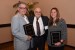 Dr. Nagib Callaos, General Chair, giving Dr. Ronald A. Styron, Jr. and Dr. Jennifer Styron a plaque "In Appreciation for Delivering a Great Keynote Address at a Plenary Session."